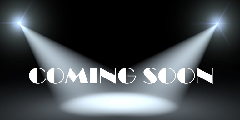 Black background with 2 stage lights from the side and the words "Coming Soon"